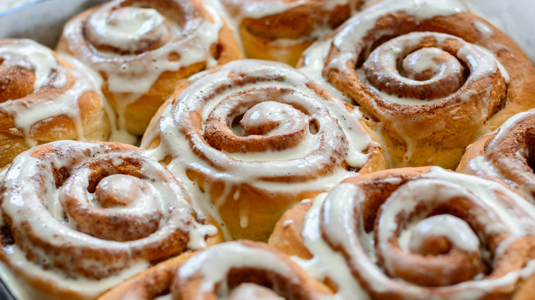 Golden brown cinnamon rolls with icing.