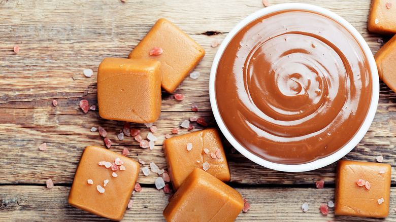 Caramel pieces of candy on wood table