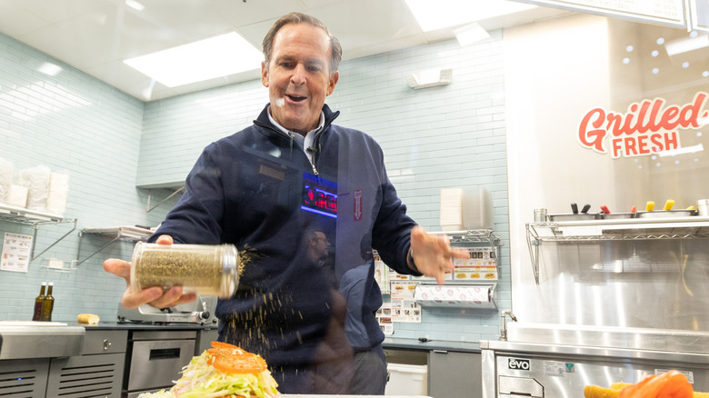 Jersey Mike's CEO Peter Cancro seasoning sub sandwich