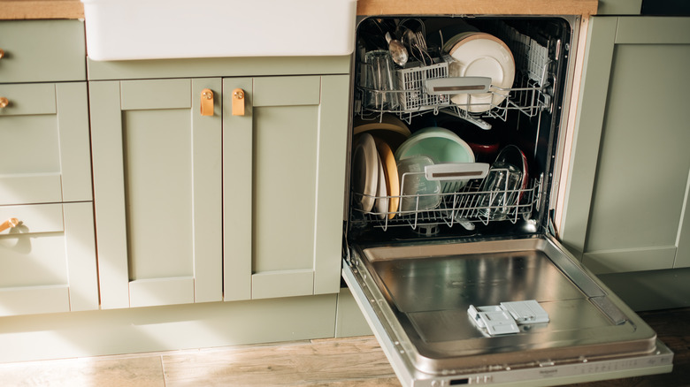 An open dishwasher with clean dishes.