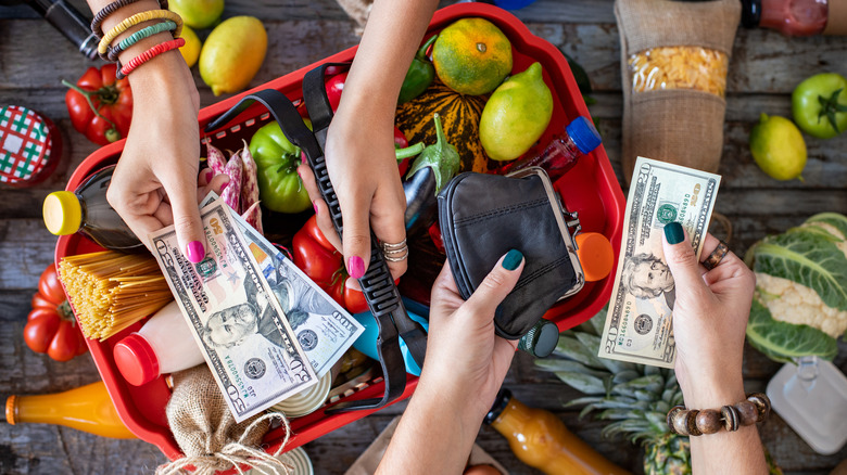 Hands swapping money and groceries