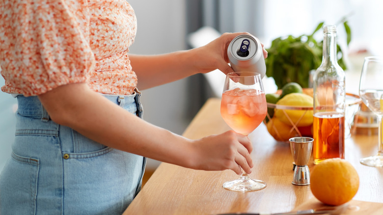 Pouring canned wine into a glass