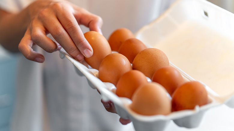 Picking egg from a carton