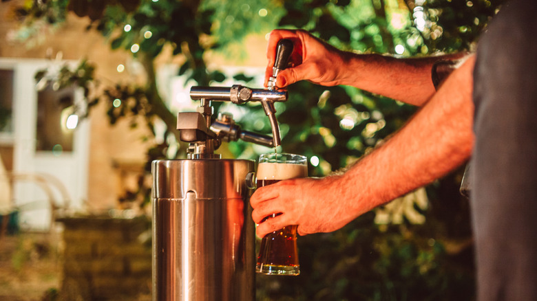Beer pours from a keg into someone's glass