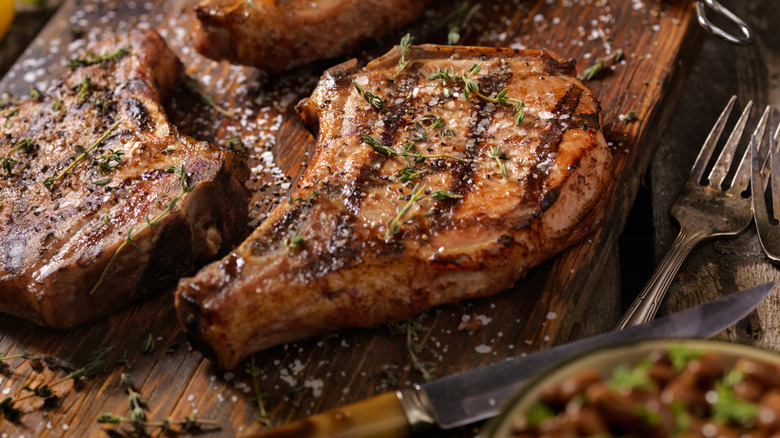 roasted pork chops on a wooden cutting board