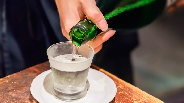 A person pouring refrigerated sake