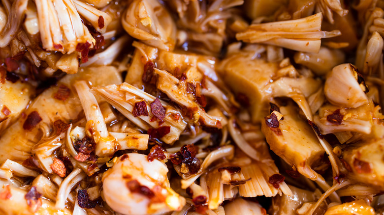 A close-up of shredded jackfruit, marinated pulled pork-style with chile flakes.