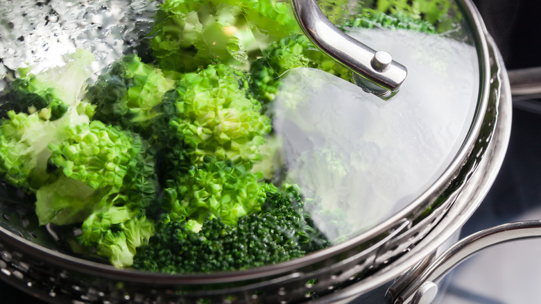 Broccoli steaming in a steamer basket