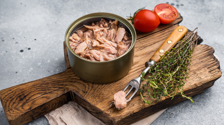 Canned tuna on wooden board