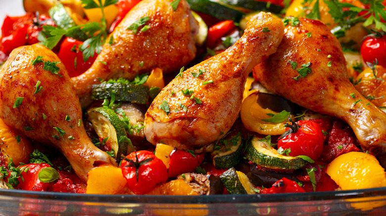 Grilled chicken legs served with vegetables.