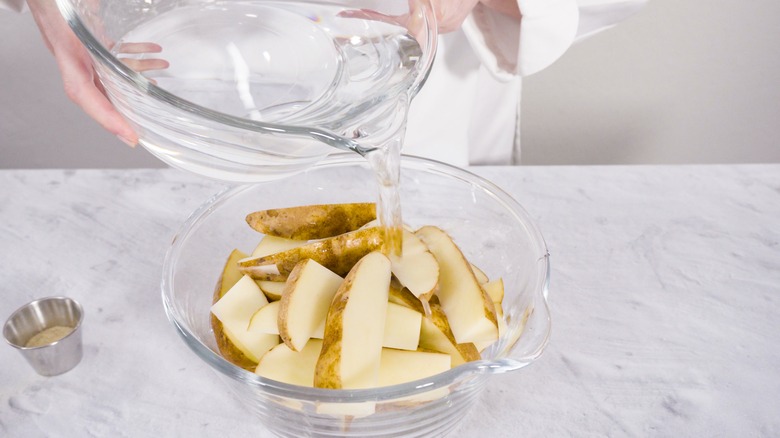 soaking wedge fries in bowl