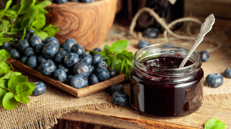 Blueberry jelly jar beside blueberries
