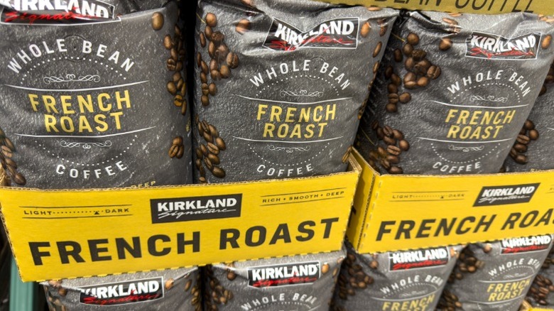 Bulk bags of Kirkland brand coffee stacked up at a Costco warehouse store.