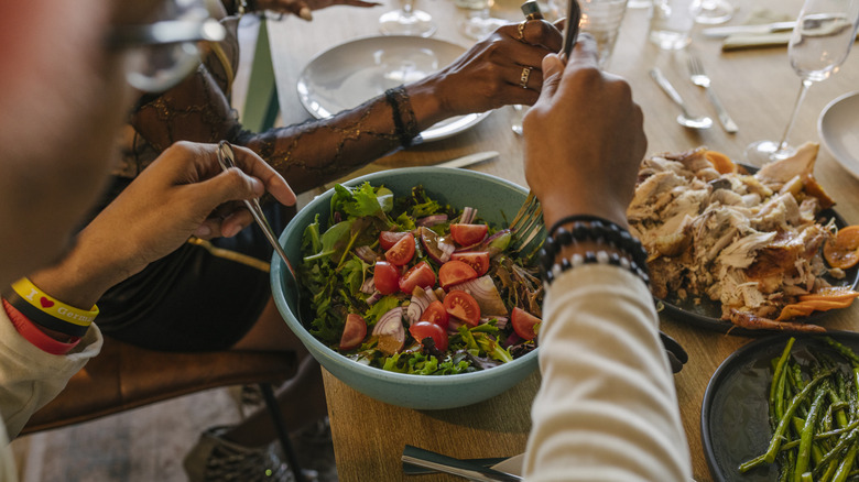 Serving salad at dinner party