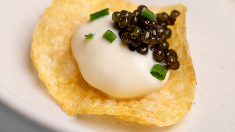 Sour cream and caviar on chip