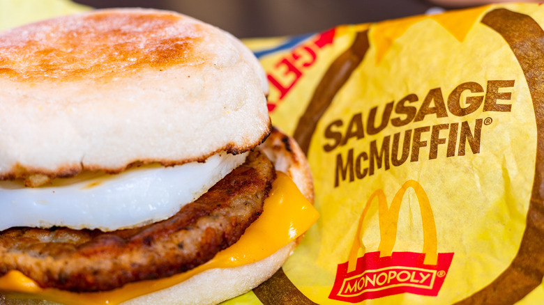 A close up of a Sausage McMuffin and its packaging