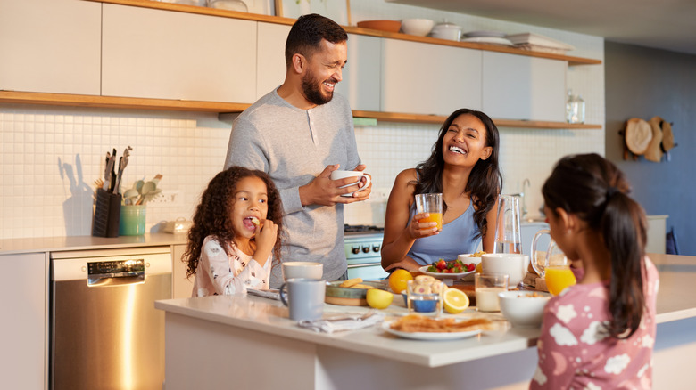 family of four enjoying breakfast in their kitchen