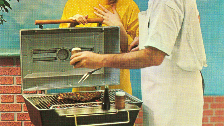 a vintage photo of a couple grilling steaks together