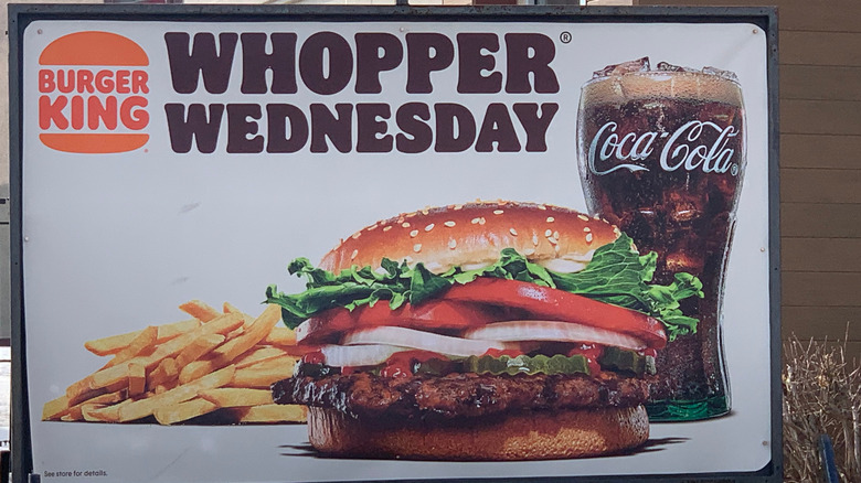 Burger King Whopper Wednesday sign featuring burger with fries and Coke