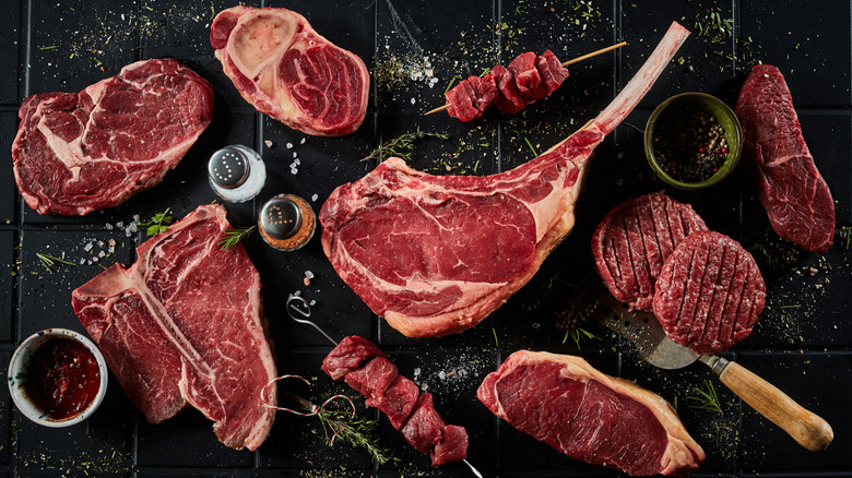 A variety of beef cuts on a dark countertop