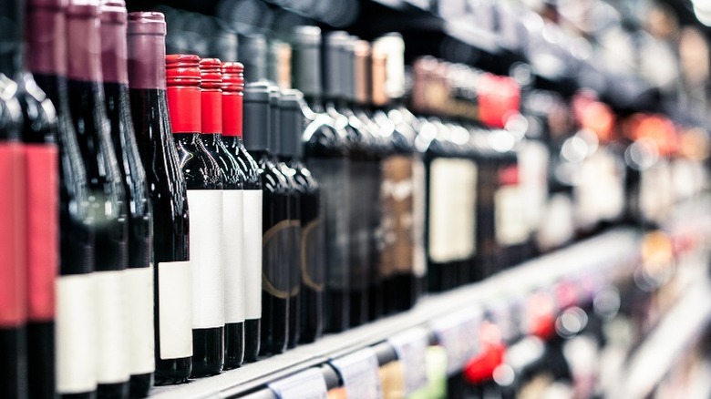 Bottles of red wine on a liquor store's shelves