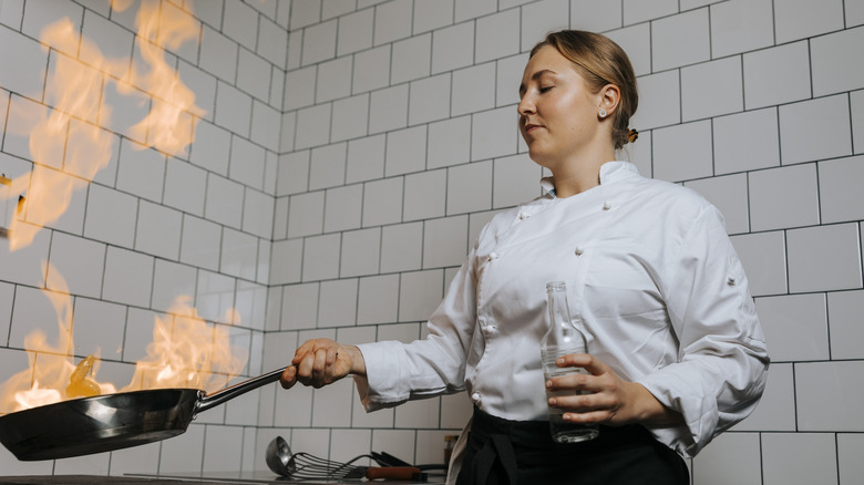 chef with flaming pan