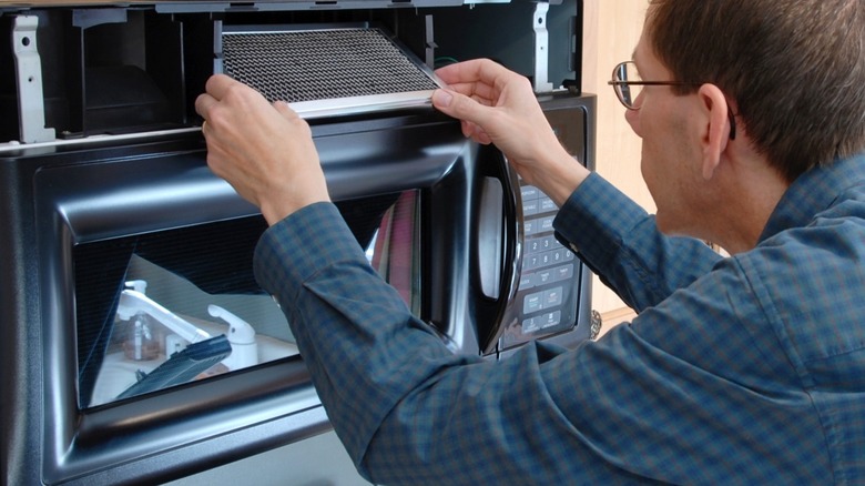 Replacing charcoal filter in microwave