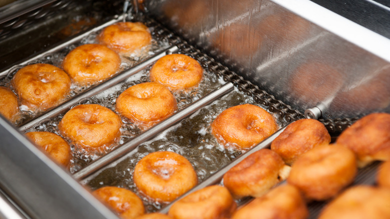 Donuts cooking in deep fryer