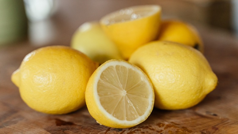 ripe eureka lemons, one sliced in half