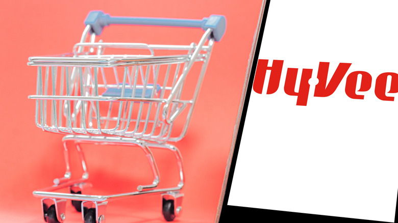 a small grocery cart next to phone screen saying hy-vee