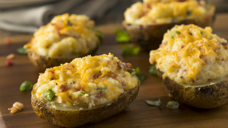 Baked potatoes on wooden board