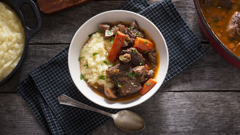 mashed potatoes served under beef stew