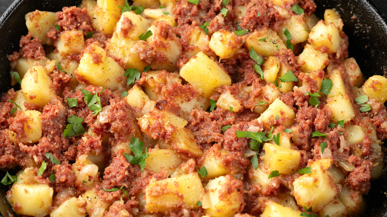 corned beef hash with potatoes in a pan