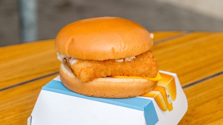 A McDonald's Filet-O-Fish sandwich on top of a branded box