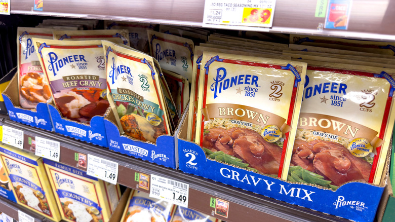 Packets of gravy seasoning packets on a grocery store shelf.