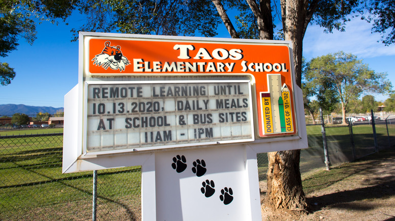 An elementary school sign advertising daily meal pickup times