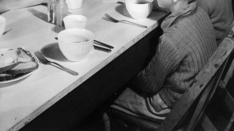 Girls sitting around a table at school eating lunch