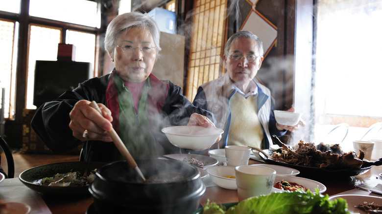 Elderly people eating food at an Asian restaurant