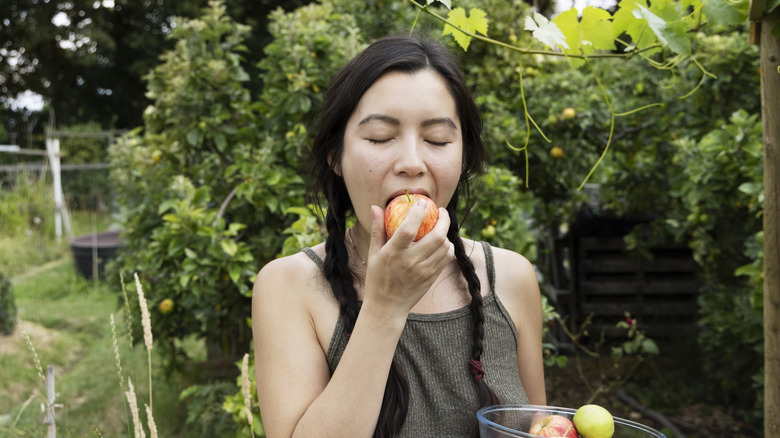 person biting into an apple