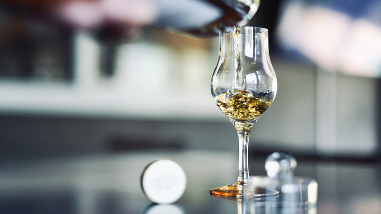 Scottish whisky being poured into a whisky glass