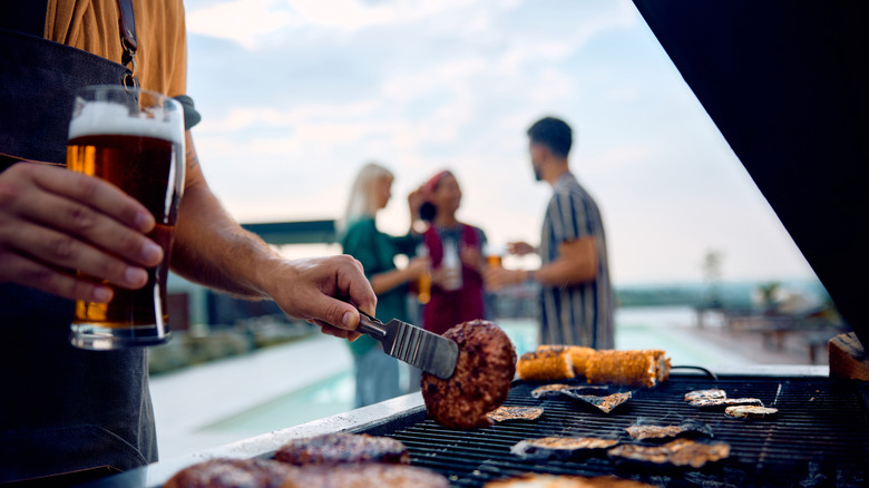 A closeup of a man cooking food on a barbecue