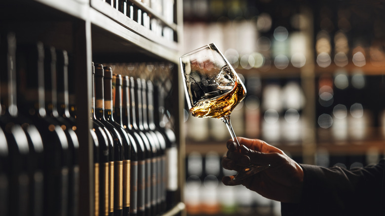 A sommelier swirls a wine glass