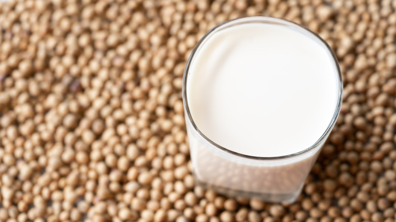 A glass of soy milk on soybeans