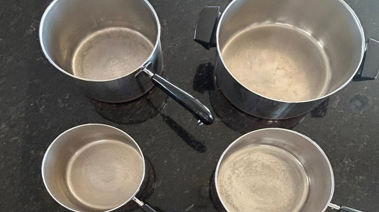 Four Revere Ware pots of different sizes.