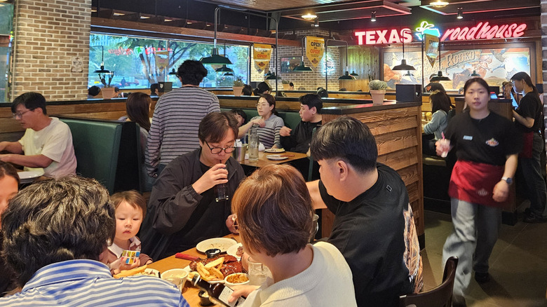 Interior of a busy Texas Roadhouse restaurant.