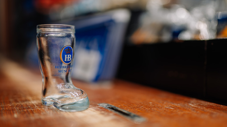 Empty beer boot on wooden bar counter