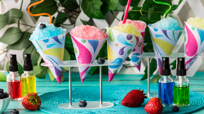 Snow cones on display with various colored syrups