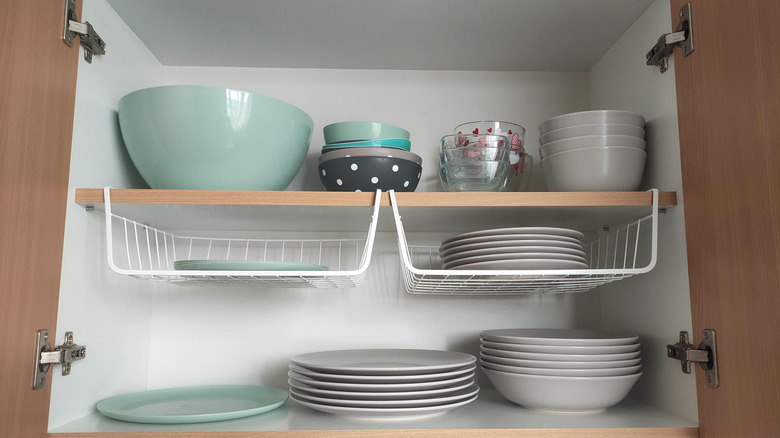 Assorted dishes arranged neatly in a kitchen cabinet