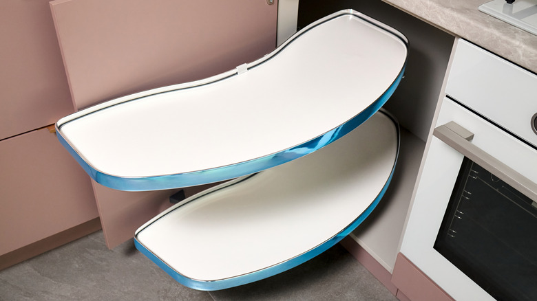 Kitchen access mechanism extending out of a kitchen cabinet