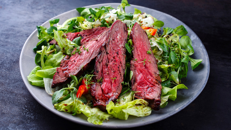 Steak salad on white plate